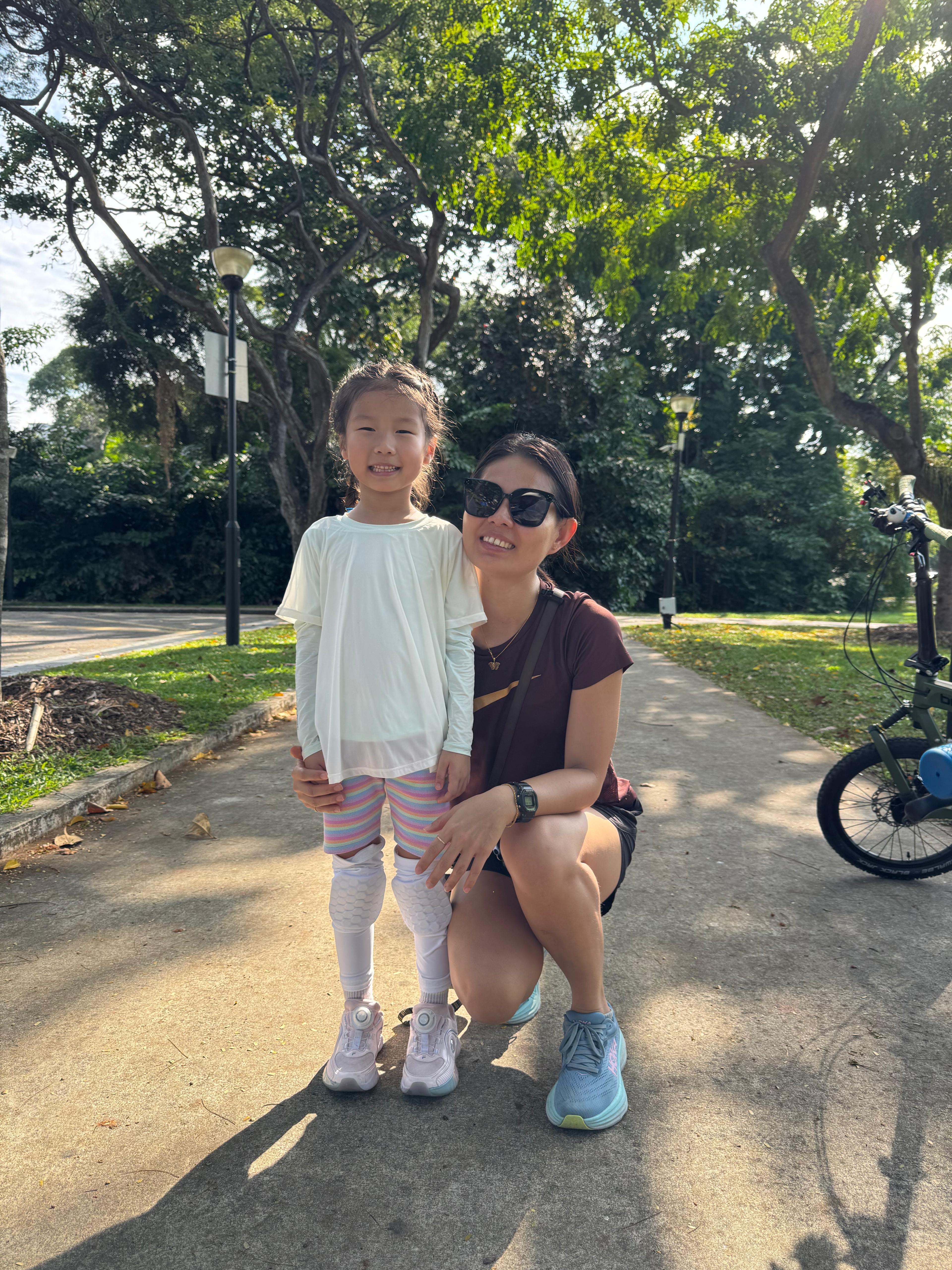 A young rider on a full-size bike along East Coast Park, Singapore